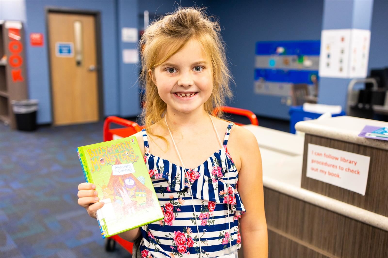 Student holding a checked out book
